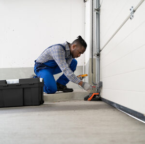 A garage door contractor working on a door