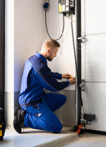 A garage door technician completes a door installation or repair