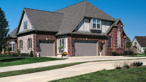 A large suburban home with newly installed garage doors